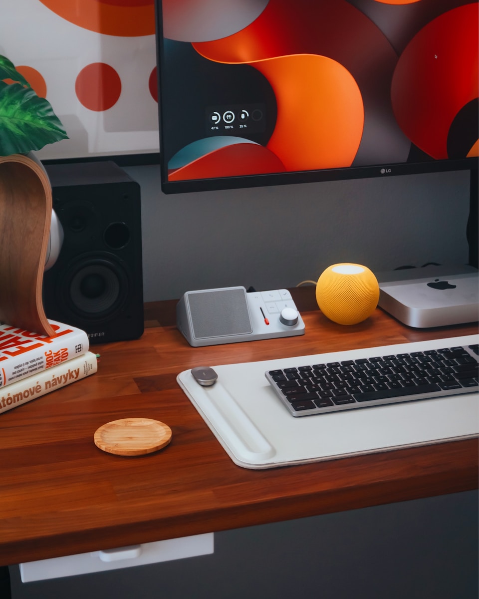 A computer desk with a keyboard, mouse, and a monitor