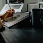 person holding silver fork on white paper