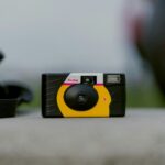 selective focus photograph of black and yellow Kodak camera